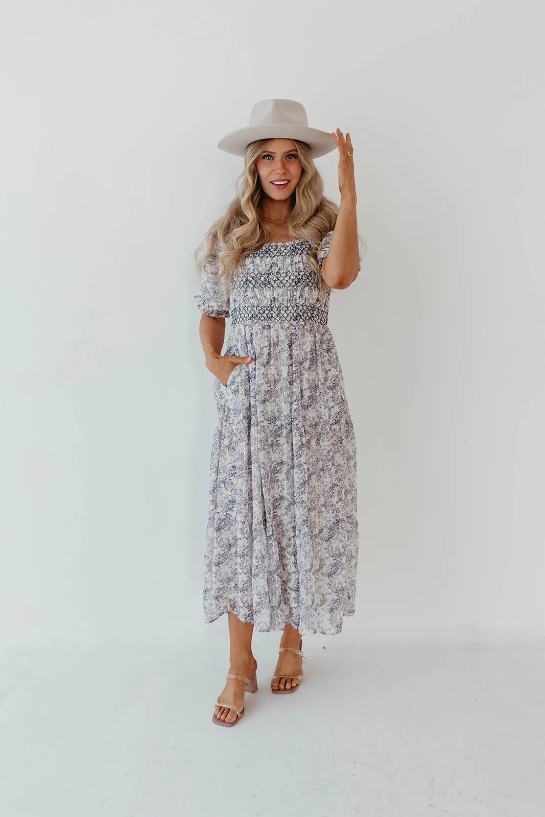 THE AYDELYNN SMOCKED MIDI DRESS IN NAVY FLORAL