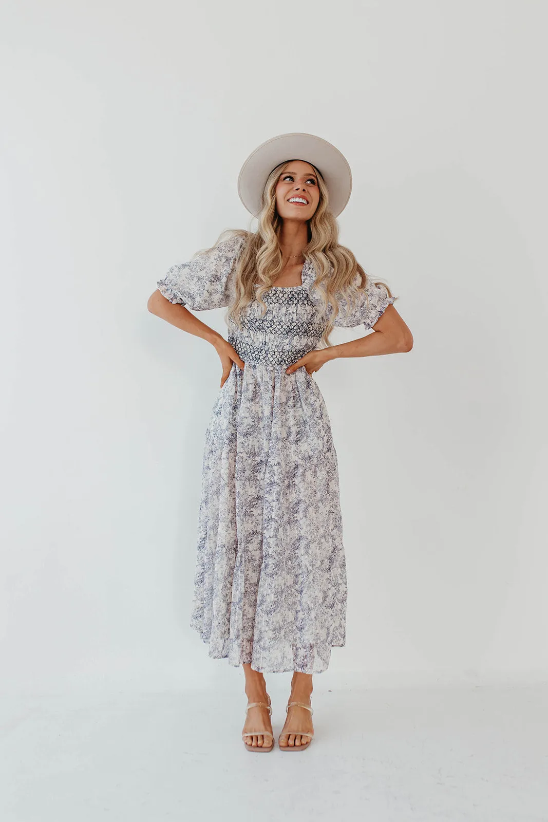 THE AYDELYNN SMOCKED MIDI DRESS IN NAVY FLORAL