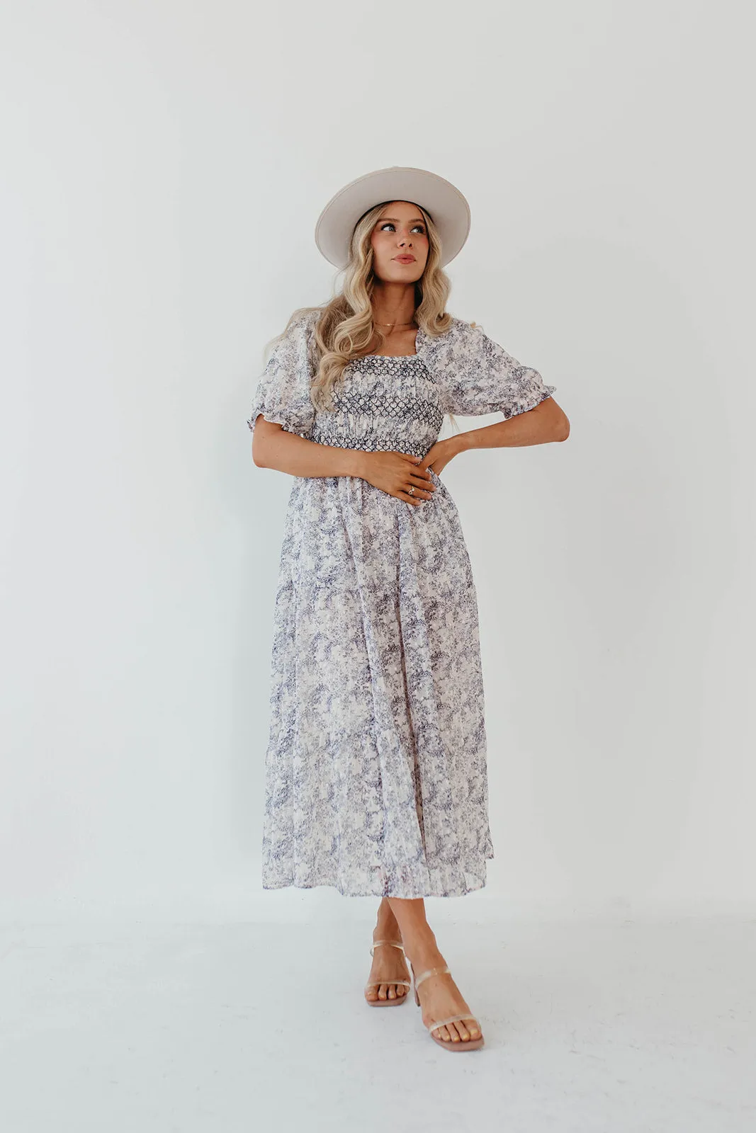 THE AYDELYNN SMOCKED MIDI DRESS IN NAVY FLORAL