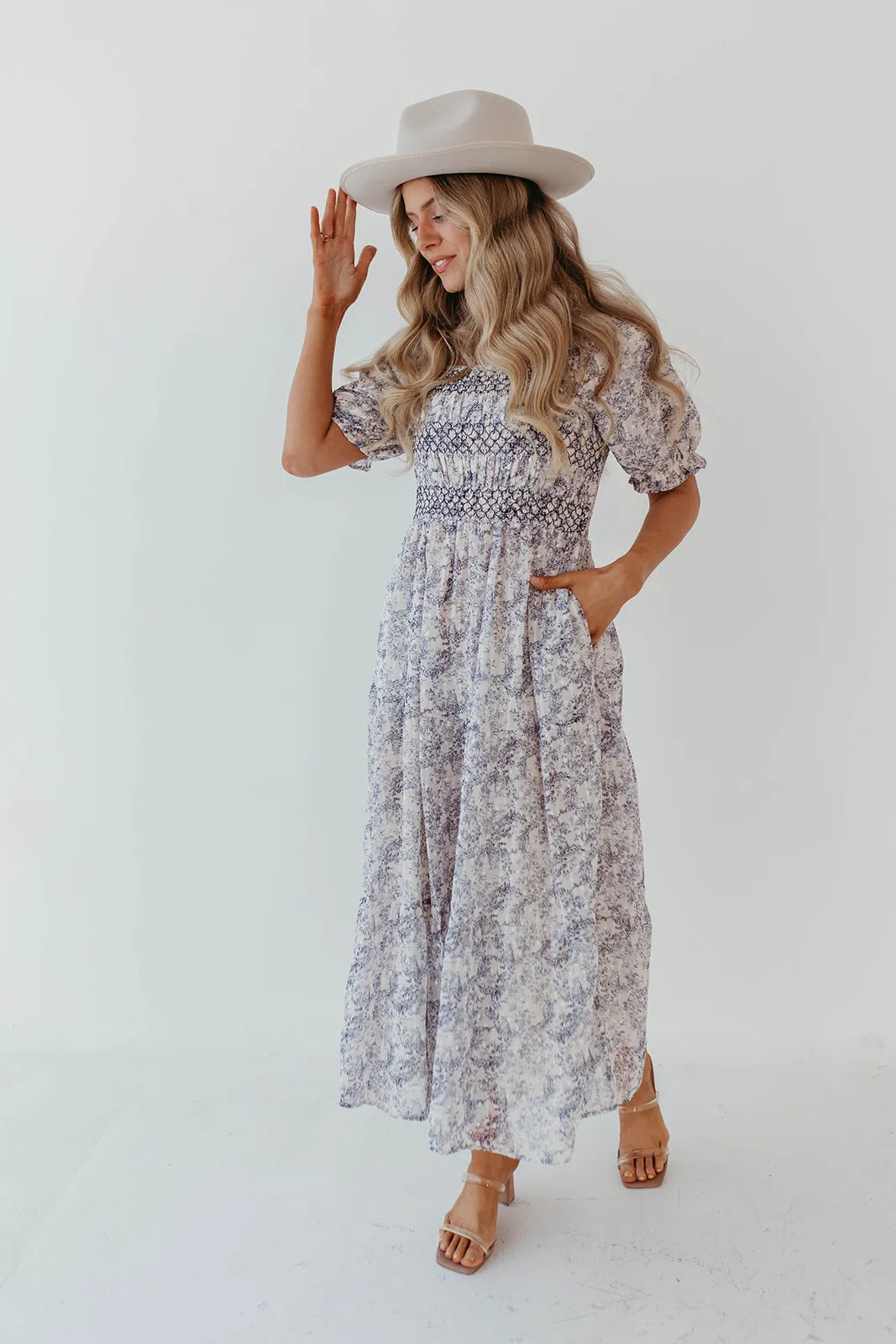 THE AYDELYNN SMOCKED MIDI DRESS IN NAVY FLORAL