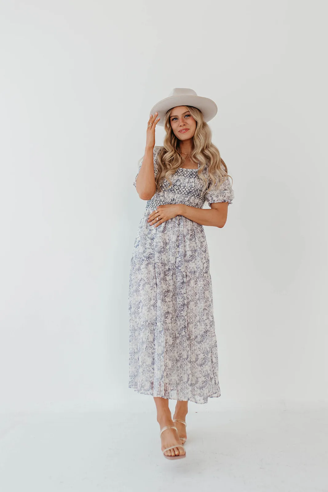 THE AYDELYNN SMOCKED MIDI DRESS IN NAVY FLORAL