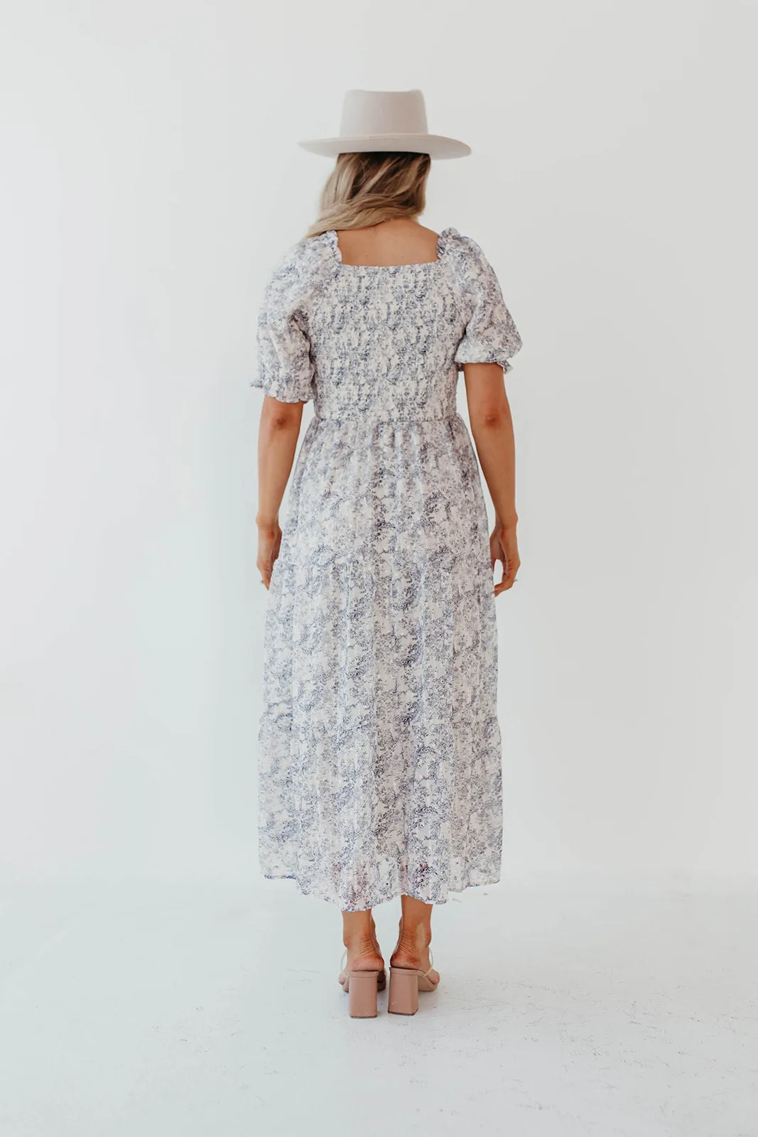 THE AYDELYNN SMOCKED MIDI DRESS IN NAVY FLORAL