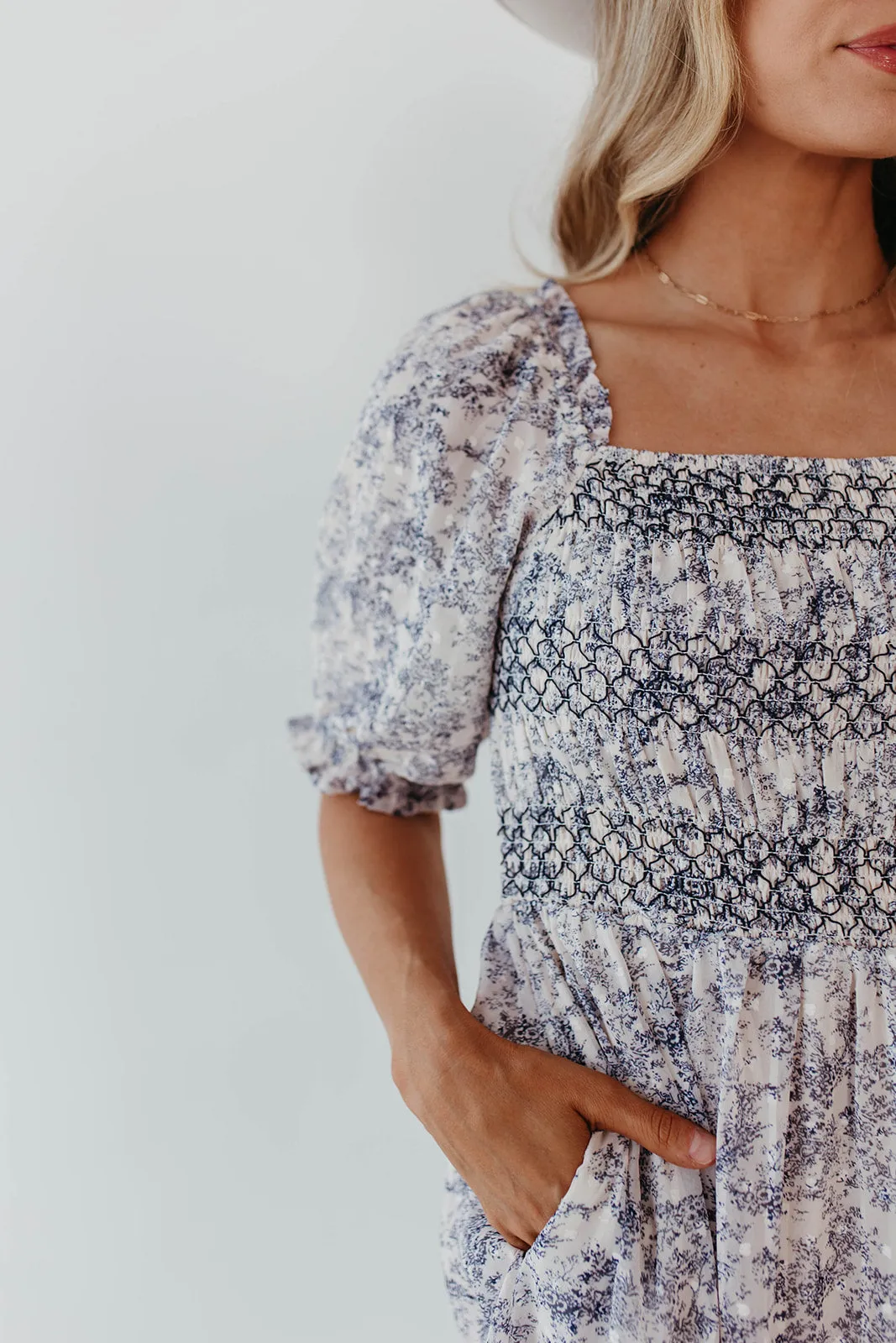 THE AYDELYNN SMOCKED MIDI DRESS IN NAVY FLORAL